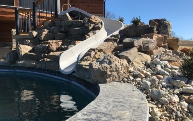 Swimming Pool slide with rock surrounding